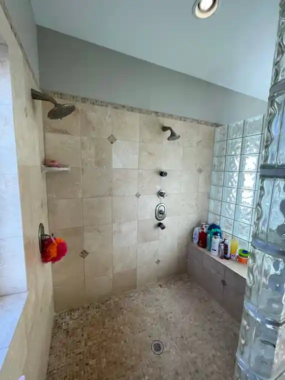 Before: a bathroom shower in dated tile