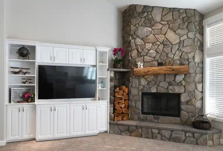 Nickoloff living room with white built-ins and a river-rock fireplace