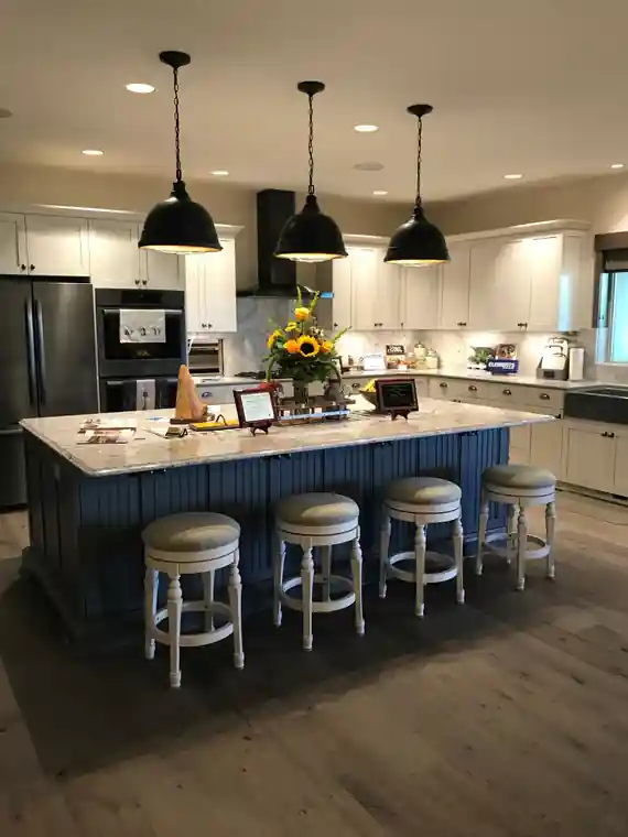 Bernier kitchen with a navy island and black pendant lights