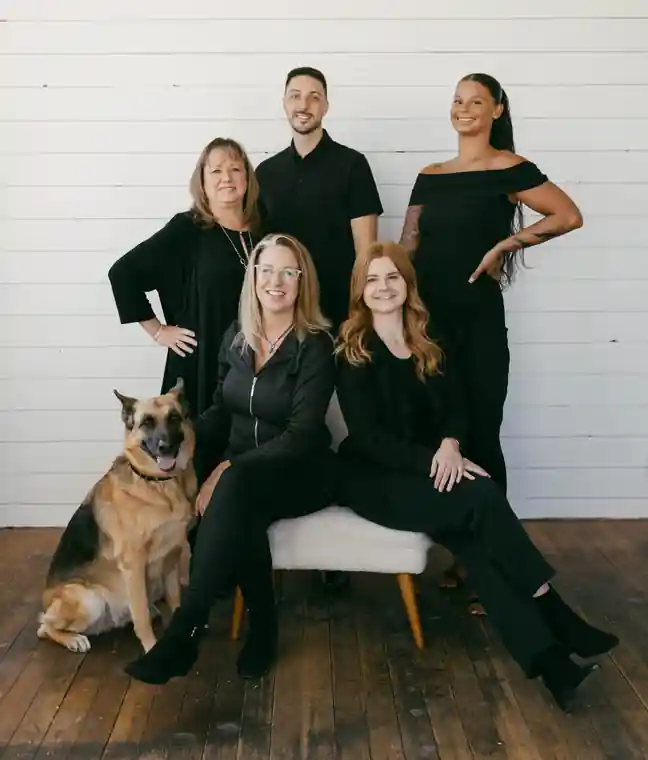 The M.B. Designs team gathered in the studio with the shop dog